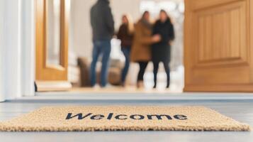 A warm welcome is shared as friends embrace at the door, with a bright, inviting living room visible behind them photo