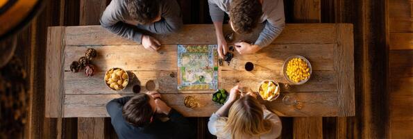 Happy adults share playful moments over board games and snacks in a cozy atmosphere, kidults concept photo