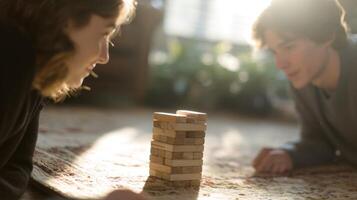 Adult siblings enjoy a game of Jenga, displaying suspense and joy in a cozy, sunlit living room, kidults concept photo