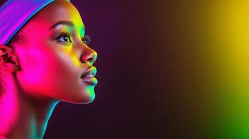 A woman in sportswear shows an expressive look with vibrant colors and creative lighting on a minimalist background photo