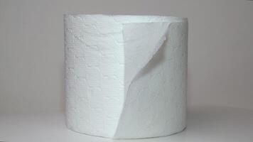 Double-layer toilet paper. Close-up of a rotating roll of soft toilet paper on a white background. The concept of hygiene, cleanliness, and care video