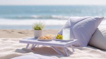 Youth enjoy a mindful summer picnic on the beach with vegan snacks, drinks, and an ocean backdrop photo