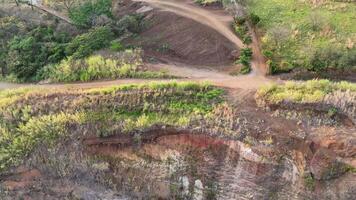 A dirt road with a dirt path leading to a hill video
