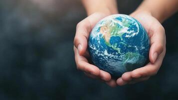 Hands cradle a globe, highlighting responsibility and love for the environment against a dark backdrop photo