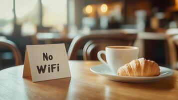 Enjoy tea and a fresh croissant while embracing a no WiFi atmosphere to recharge and relax in a cozy cafe photo