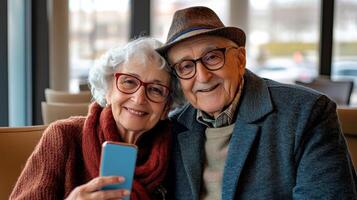 Elderly couple smiles while taking a selfie at an airport lounge before their journey photo