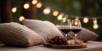 Enjoy a stylish picnic featuring artisan food, wine glasses, and warm lighting for a cozy atmosphere photo