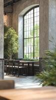 Cafe interior showcases tall windows and metal decor, filled with greenery and modern urban textures photo