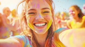 A joyful tourist woman covered with colored gulal powder make selfi, celebrating Holi outdoors photo