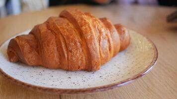 Croissant served on a plate in a cozy cafe video