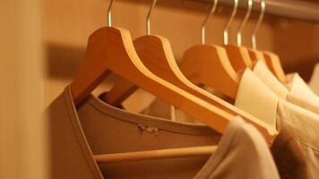 Organizing clothes in a wooden closet for better storage video