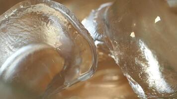 Transparent ice melting in warm sunlight during a summer day video