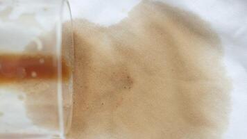 Coffee spills on a light fabric surface creating a stain video