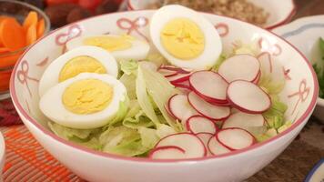 Fresh salad preparation with eggs and radishes in a bowl video