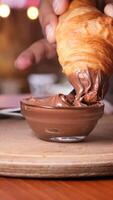 Smooth chocolate spread is applied to a fluffy croissant. video