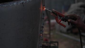 Welding metal structure during evening work session video