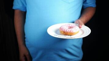 Holding a donut on a plate in casual setting video