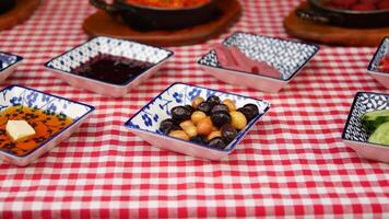 Colorful spread of appetizers on checkered tablecloth video