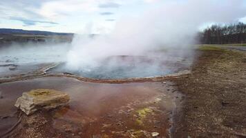 Hot spring pool Geysir in Iceland boiling and waiting to erupt slow motion video