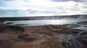 Hot spring pool Geysir in Iceland boiling and waiting to erupt panning video