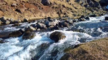 Small river with strong stream flowing down near Kerlingarfoss waterfall in Iceland video