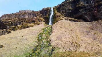 Small waterfall next to Seljalandsfoss waterfall in Iceland slow motion video
