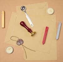wax seal kit including wax sticks, spoon, candles, stamp and sealed scroll placed on a neutral background photo