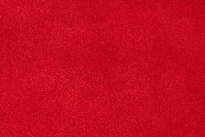 Close up of rich red suede showing the soft, shaggy surface texture with visible fibers photo