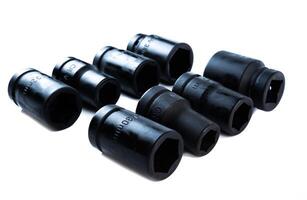 Set of heavy-duty impact sockets in various sizes arranged on a white background, ideal for automotive repair, mechanic shops, or garage tool kits. photo