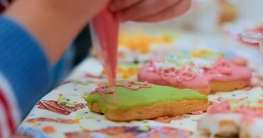 Child Decorating Colorful Cookies with Icing in Close-Up View video