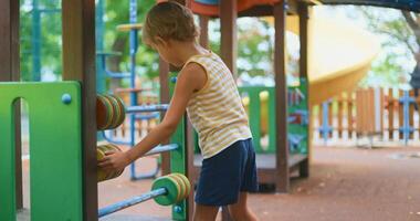 Child Playing on Colorful Playground Equipment in a Park video