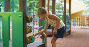 Child Playing with Abacus at Playground on a Sunny Day video