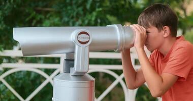 Boy Observing Through Binoculars in Park Setting video