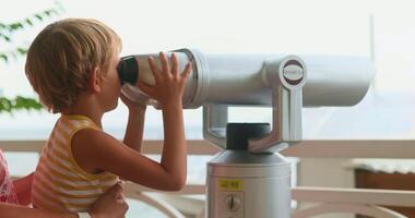 Child Exploring with Binoculars at Scenic Viewpoint video