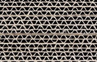 Close-up of stacked corrugated cardboard cross-sections showing wavy inner structure photo