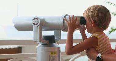 Child Enjoying View Through Coin-Operated Binoculars at Scenic Overlook video