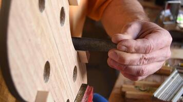 Malaga, Spain, 2017 - Luthier working in the structure of a new violin or viola in the workplace video