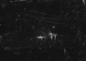Dark grunge background with dust and scratches. Abstract rough surface backdrop. White stain on dark. Suitable for poster, banner, or cover overlay. photo
