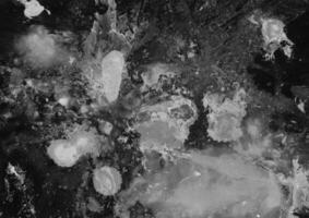 Abstract grunge dark background. Paint smudge rough texture. Dirty ink smear graphic element for overlay texture. photo