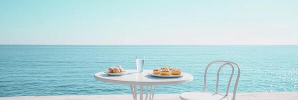 A light blue sea, a white round table with chairs and pastries on it, a glass of water in the middle of the table, a chair next to the table. photo