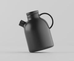 A black jug with a handle on a white background photo