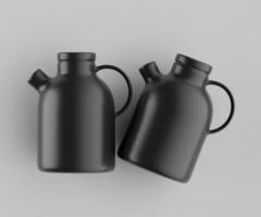 Two black kettles on a gray background photo