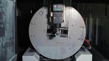Industrial CNC laser machine cutting metal cylinder, precision high-tech process, Automated rotation mechanism ensures accurate detailing for mass production video