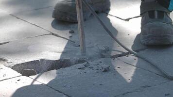 Repairing pavement with a concrete chisel in outdoor setting video