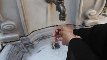 Washing hands at a decorative fountain in a courtyard video