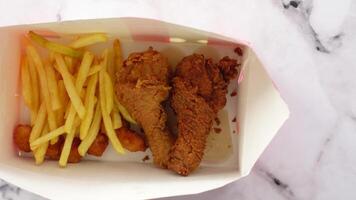 Enjoying delicious fried chicken with crispy fries video