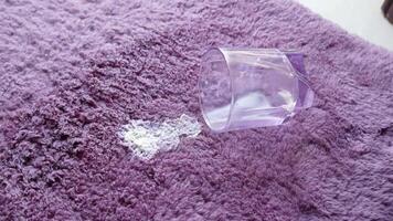 milk spilled from a glass on a floor carpet video