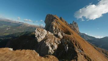 Smooth flight along the mountain range. Seceda, Italy. FPV drone shot video