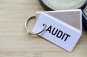 Audit text on notepad symbolizing financial review and compliance evaluation photo