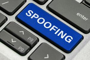 Spoofing text on keyboard showcasing threats of impersonation in digital communications photo